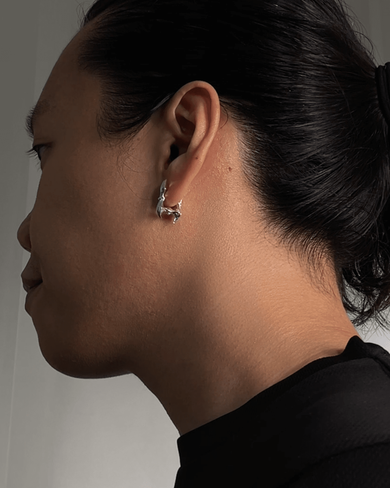 Rectangular sculptural silver earrings worn on ear – Obscure Spine Frame Edition by Oranda Jewelry