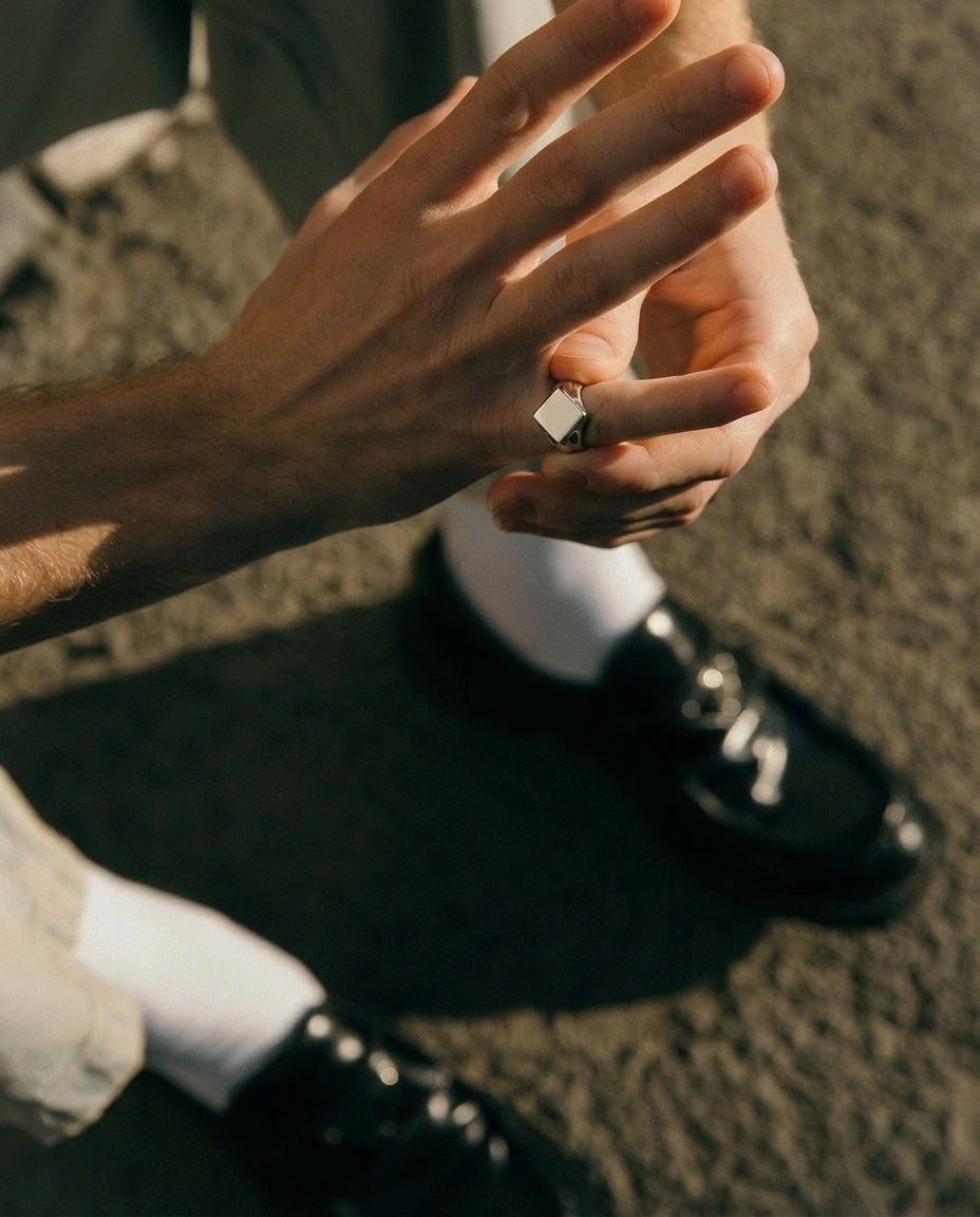 Close-up of a person's hand wearing a ring